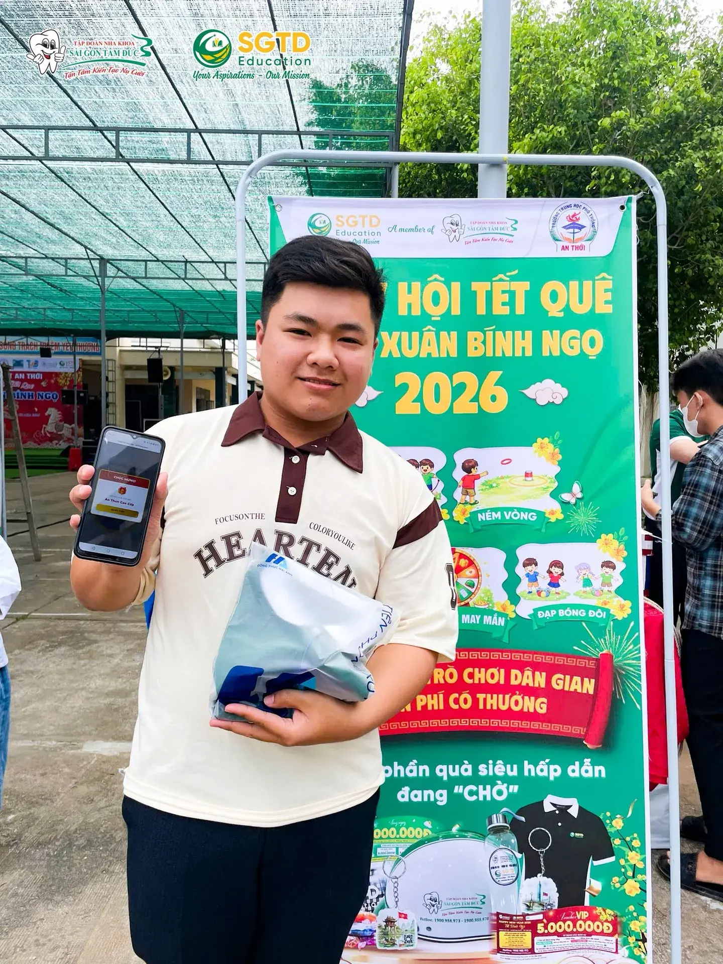 Hai học sinh nhận phần thưởng từ SGTD Education tại Gala Xuân Bính Ngọ